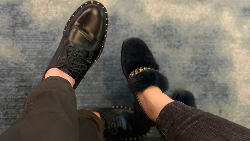 a person wearing black shoes and a pair of black pants